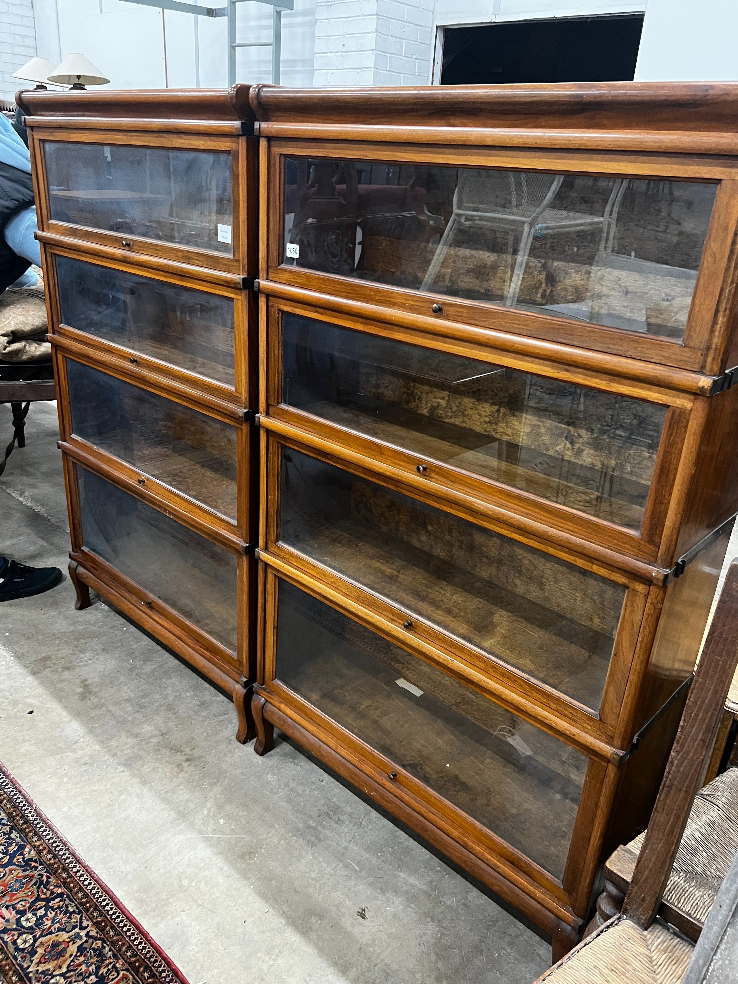 A pair of Globe Wernicke four section walnut bookcases, length 87cm, depth 31cm, height 147cm